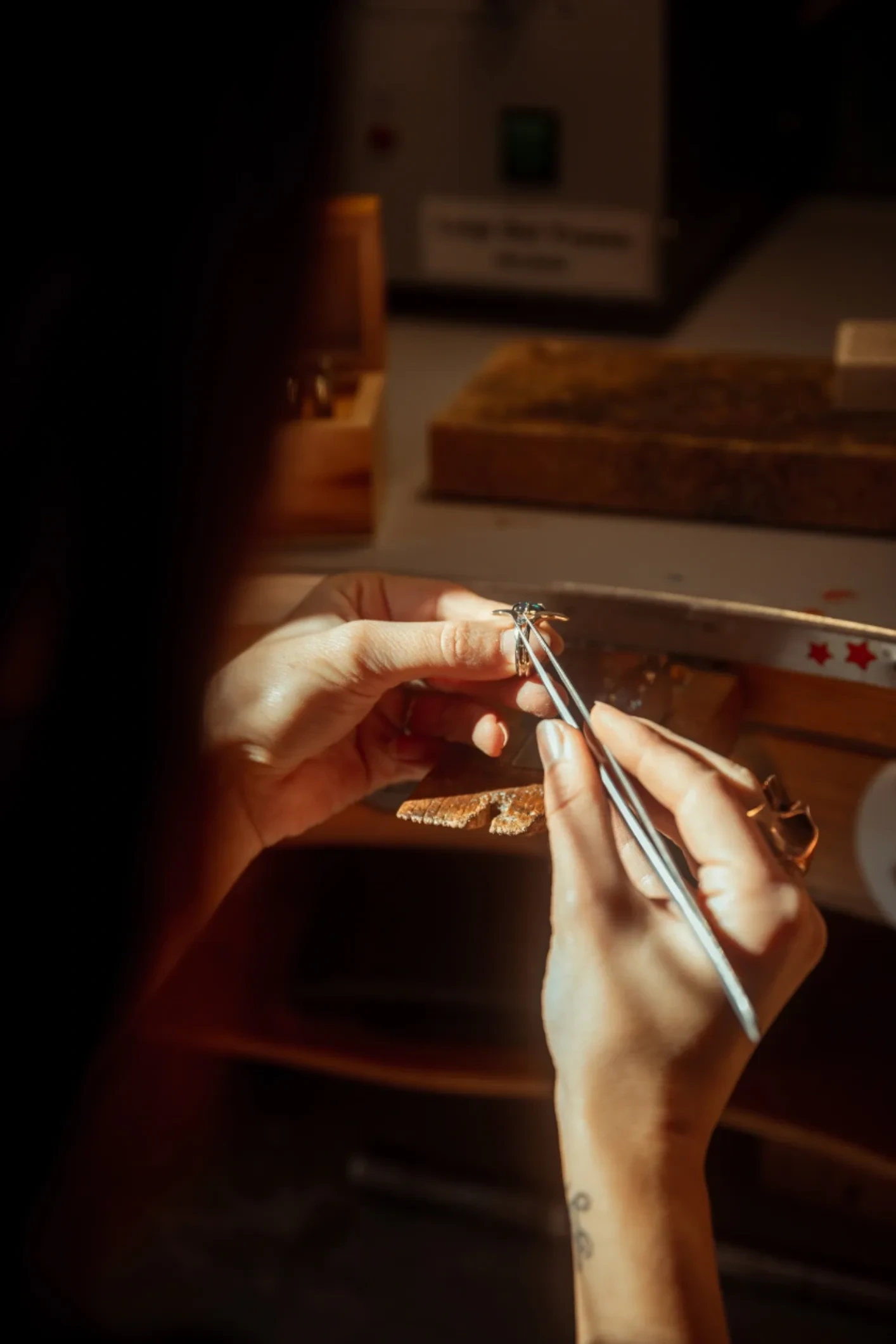 Hands making beaded jewelry