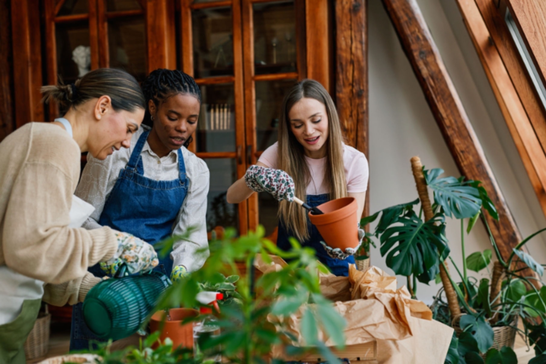 Hands potting a plant in a workshop